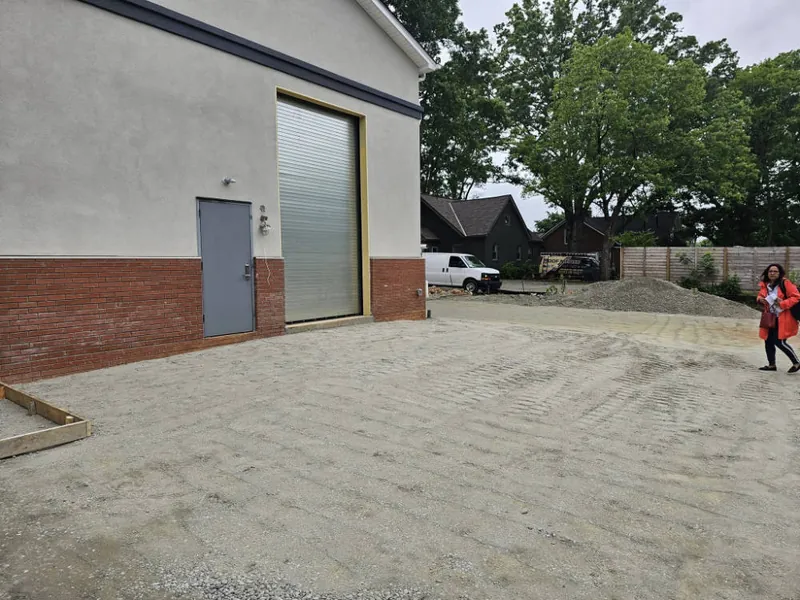 Roll-up door and entry of a new single-story commercial building on a gravel pad