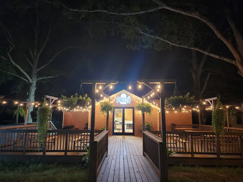 Panzu Brewery deck and pergola lit with string lights at night
