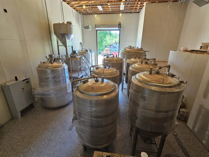 Stainless steel brewing tanks installed in the finished brewhouse at Panzu Brewery